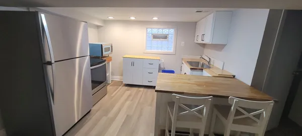 a kitchen with kitchen island a sink stove and refrigerator