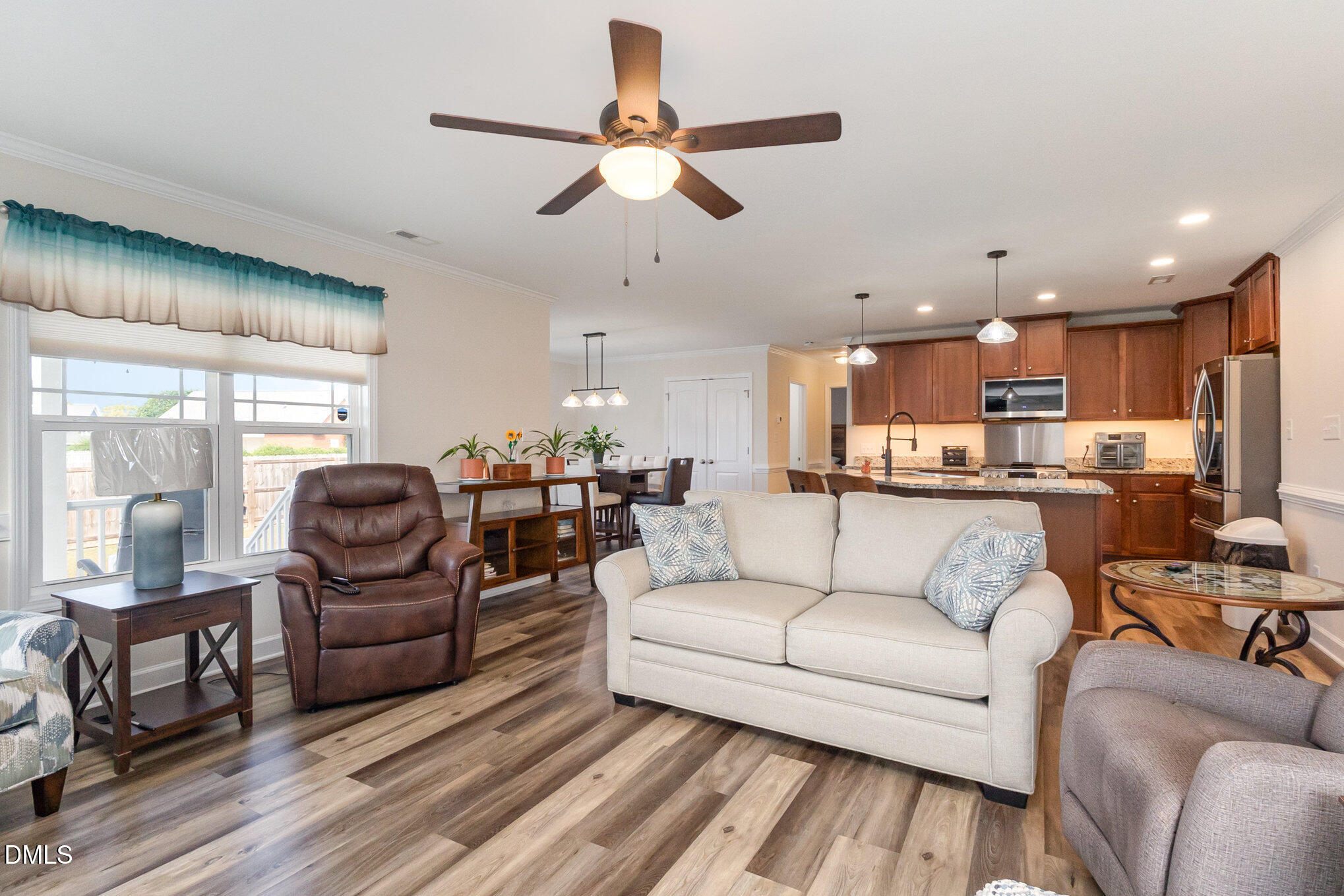 146 Wheat Drive Angier, NC 27501 - Photo 10 of 46 a living room with furniture kitchen view and a chandelier