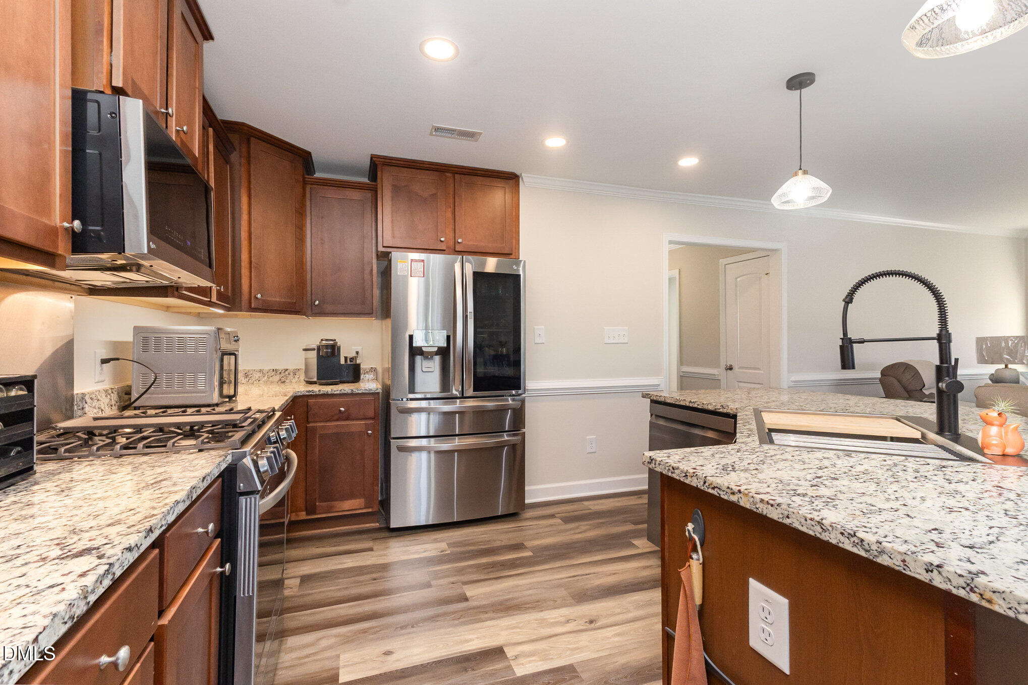 146 Wheat Drive Angier, NC 27501 - Photo 15 of 46 a kitchen with kitchen island granite countertop stainless steel appliances and wooden cabinets