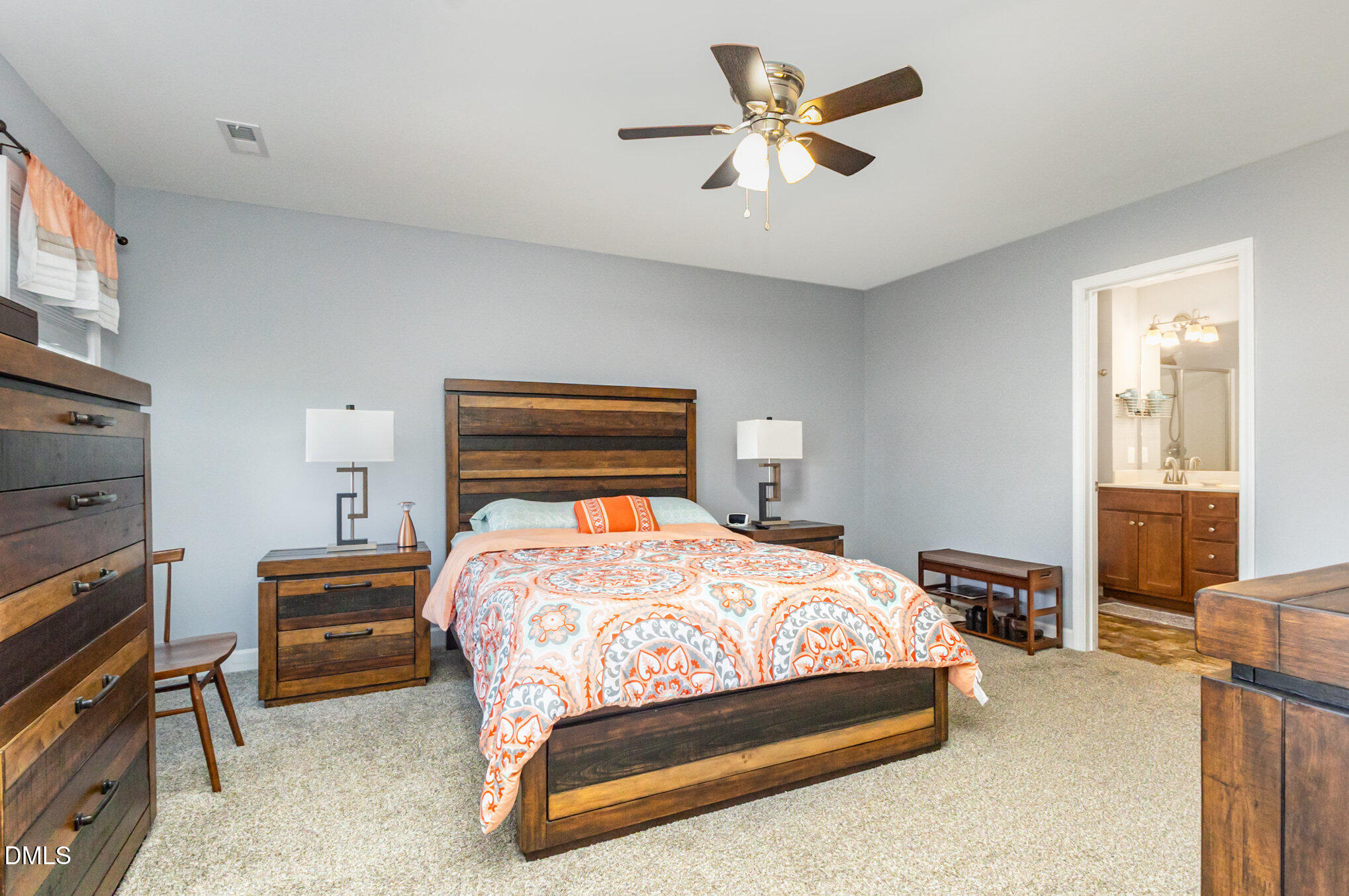 146 Wheat Drive Angier, NC 27501 - Photo 18 of 46 a bedroom with a bed a chandelier and dresser