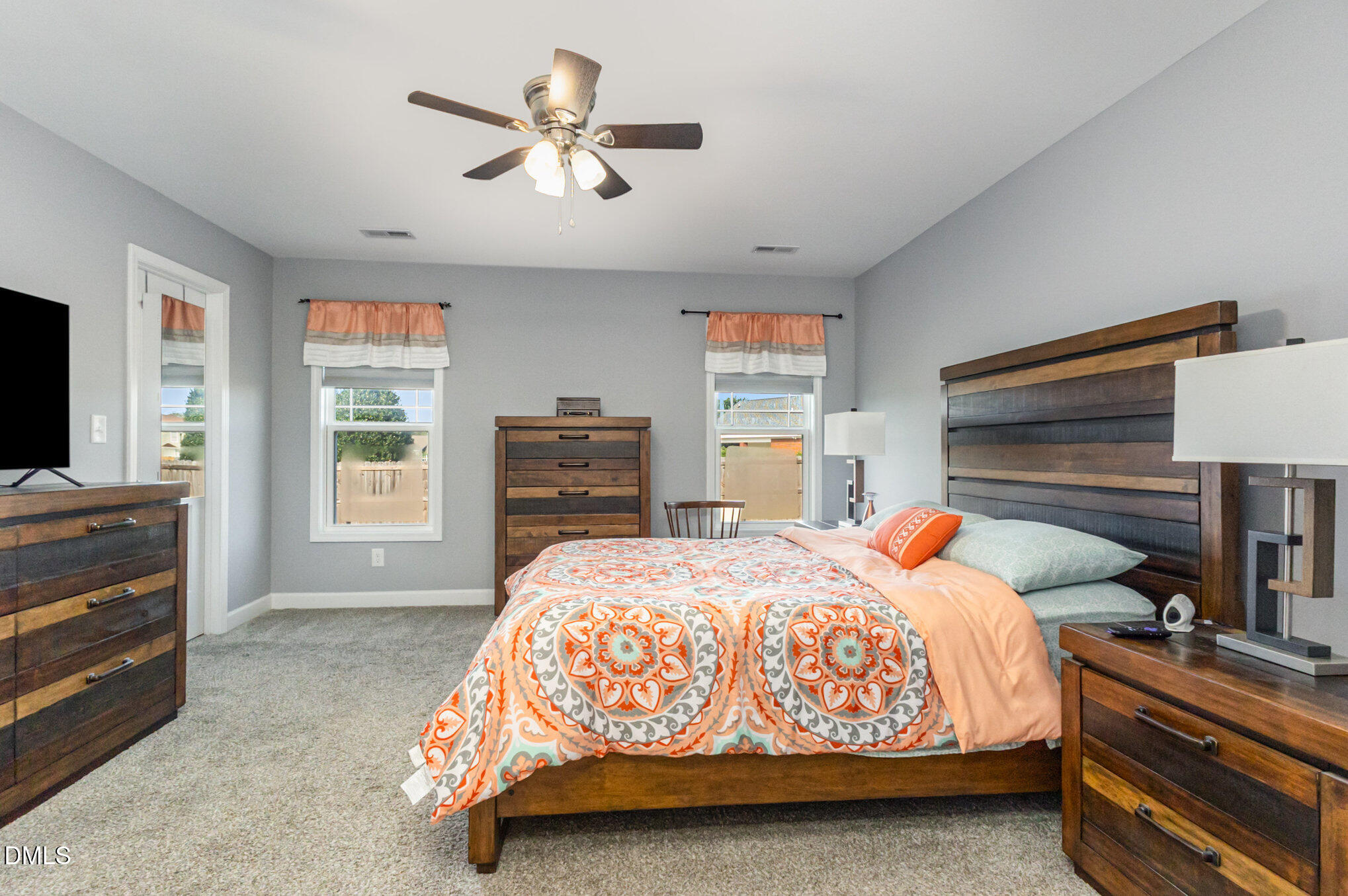 146 Wheat Drive Angier, NC 27501 - Photo 19 of 46 a bedroom with a bed a dresser and next to a window