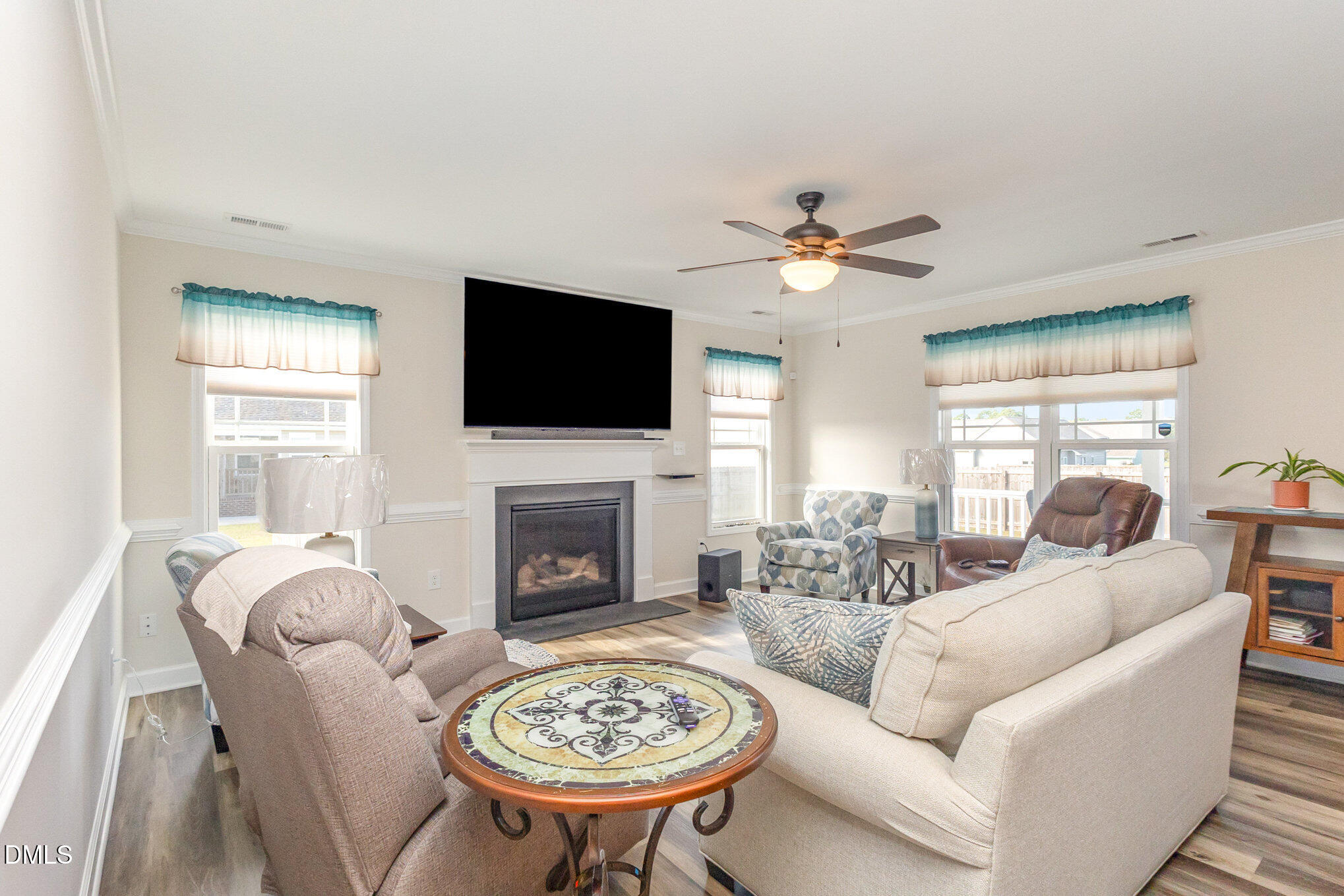 146 Wheat Drive Angier, NC 27501 - Photo 6 of 46 a living room with furniture a fireplace and a flat screen tv