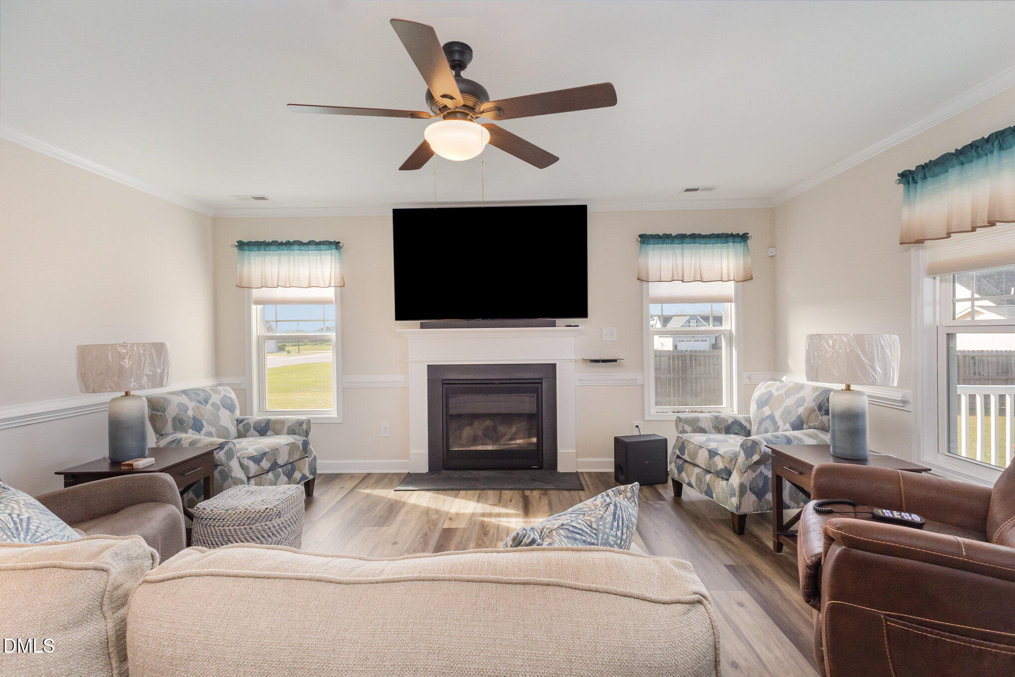 146 Wheat Drive Angier, NC 27501 - Photo 7 of 46 a living room with furniture a fireplace and a flat screen tv