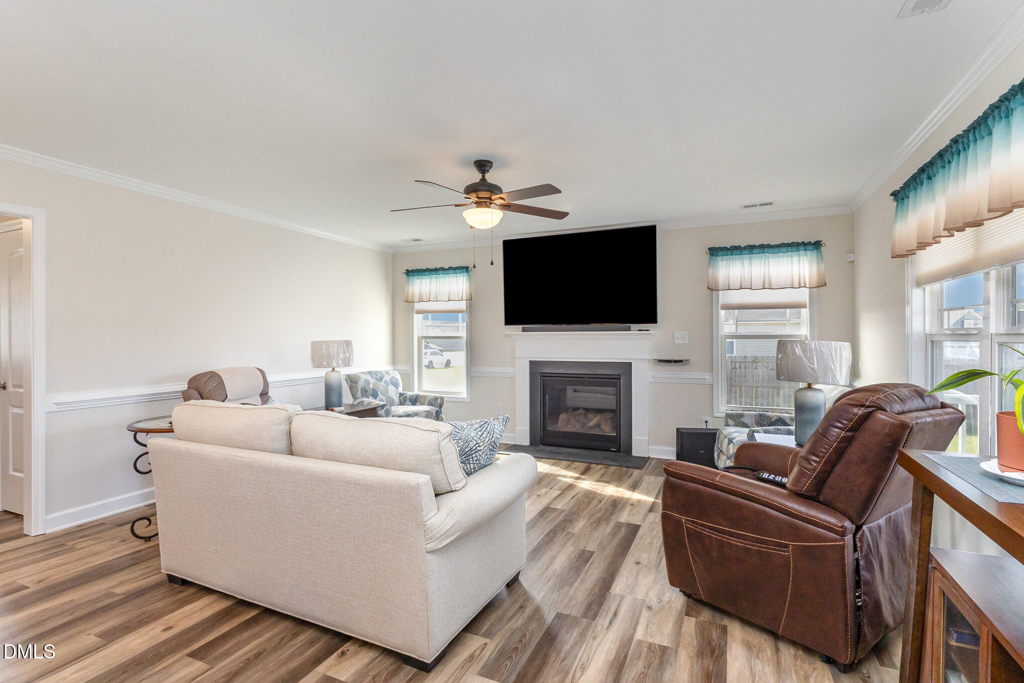 146 Wheat Drive Angier, NC 27501 - Photo 8 of 46 a living room with furniture a fireplace and a flat screen tv