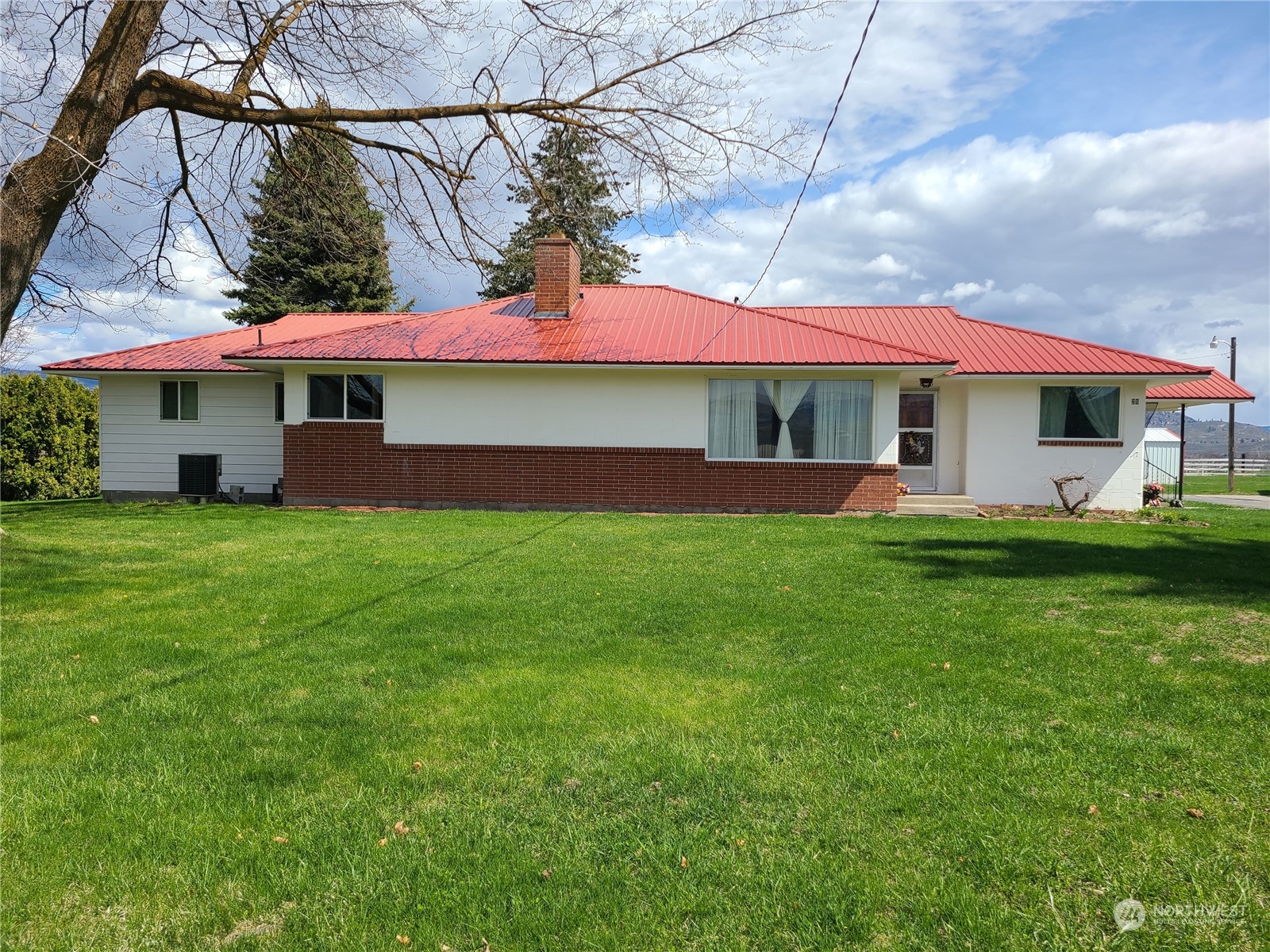 28 Robinson Canyon Road Omak, WA 98841 - Photo 3 of 33 a view of a white house with a yard and sitting area