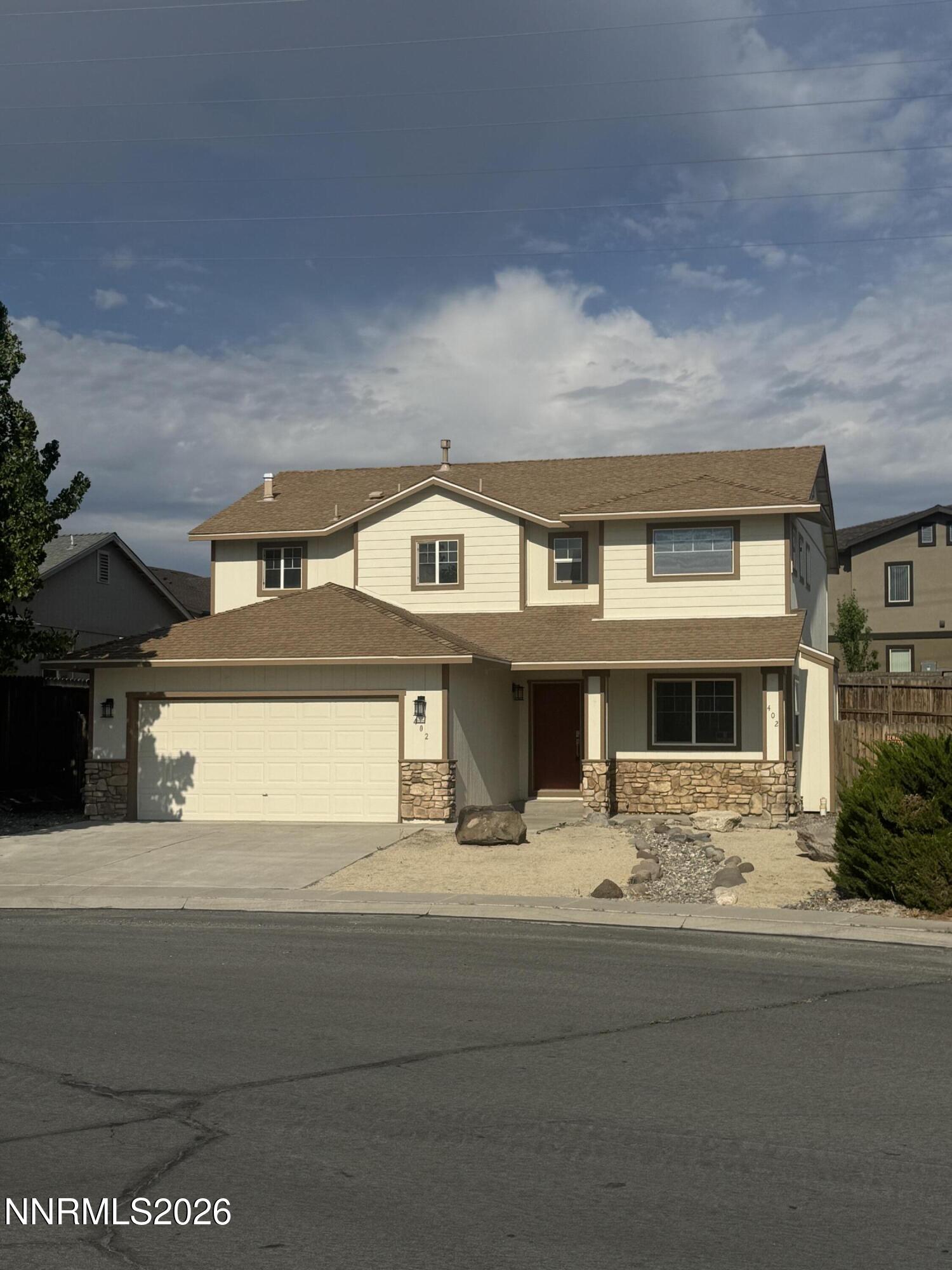 402 Fort Sutter Boulevard Fernley, NV 89408 - Photo 2 of 2 a front view of a house with yard