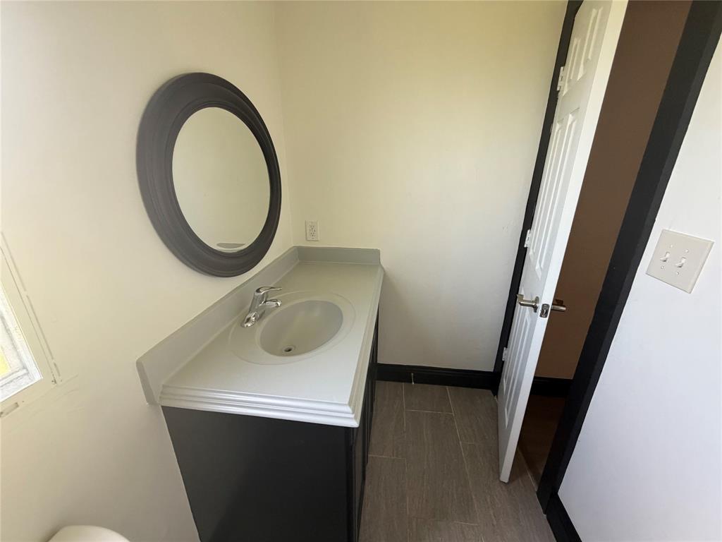 222 Hix Road Cleburne, TX 76031 - Photo 17 of 27 a bathroom with a sink and a mirror