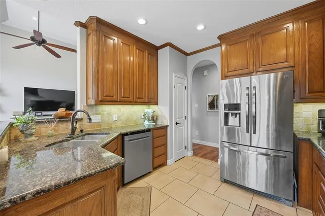a living room with furniture and a view of kitchen