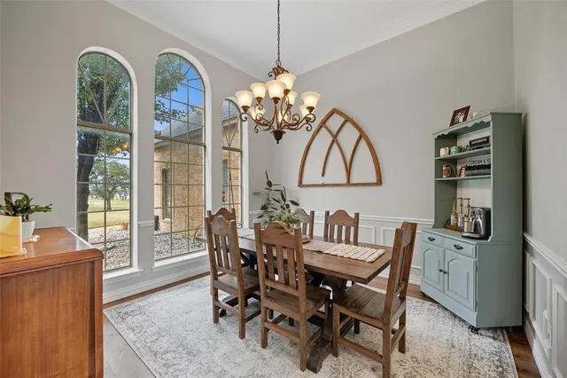 a living room with furniture a chandelier and a window