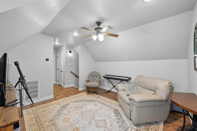 a view of a dining room with furniture and a chandelier