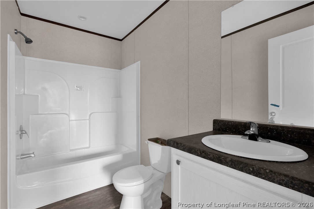 6309 Deep Branch Road Pembroke, NC 28372 - Photo 17 of 32 a bathroom with a sink toilet and shower