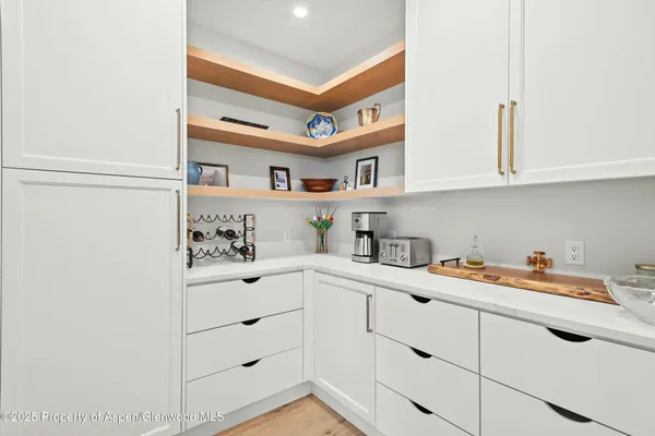 a utility room with cabinets washer and dryer