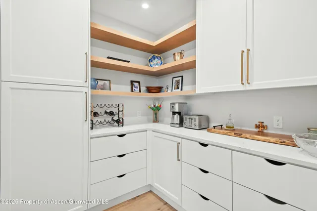 a utility room with cabinets washer and dryer