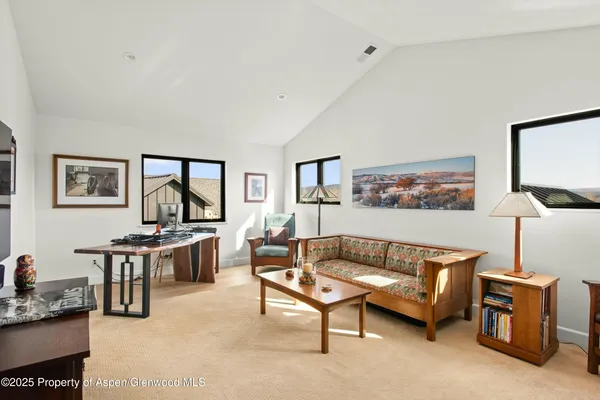 a living room with furniture a rug and a window