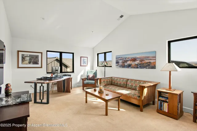 a living room with furniture a rug and a window