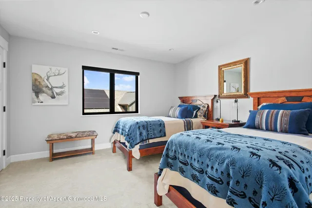 a bedroom with two beds and a couch