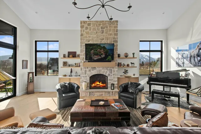 a living room with furniture a flat screen tv and a fireplace