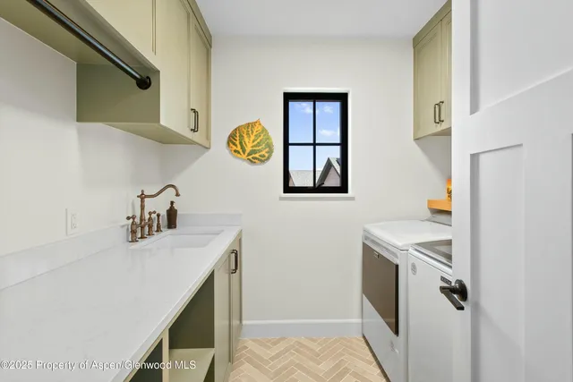 a utility room with sink dryer and washer