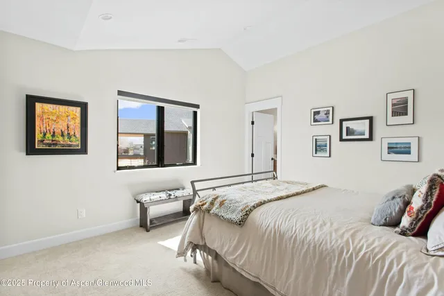 a bedroom with bed and a window