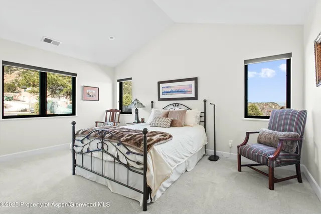 a bedroom with a bed and a couch