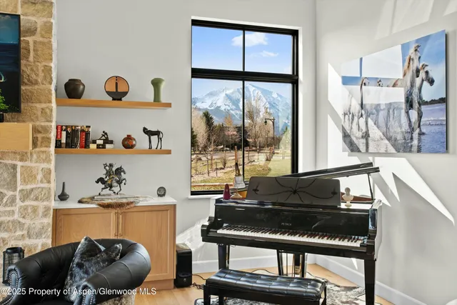 a living room with furniture and a floor to ceiling window