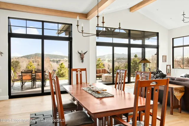 a view of a dining room with furniture window and outside view