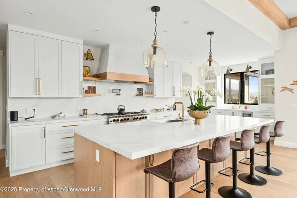 a kitchen with appliances cabinets and furniture