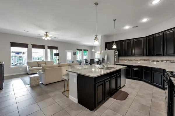 a kitchen with a counter space dining table and chairs