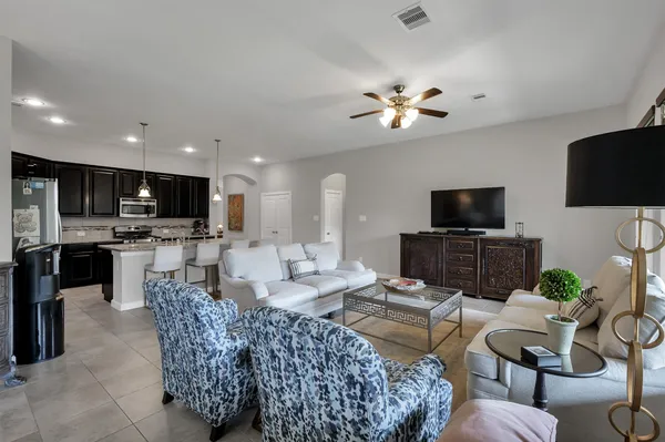 a living room with furniture and kitchen view