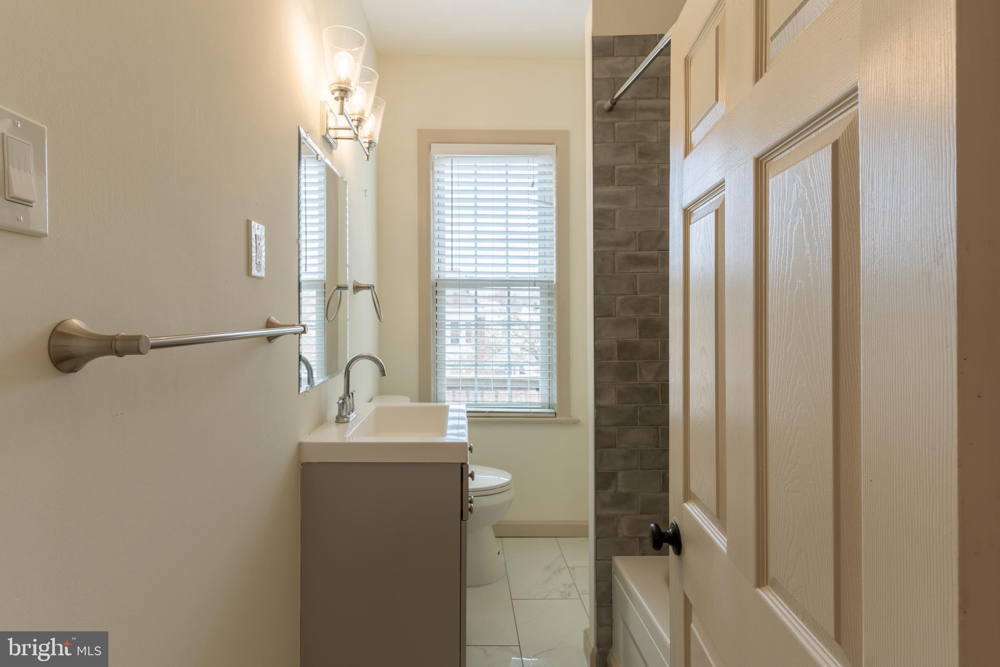 100 Potter Street, Unit 4 Haddonfield, NJ 08033 - Photo 14 of 17 a bathroom with a sink a mirror and a shower