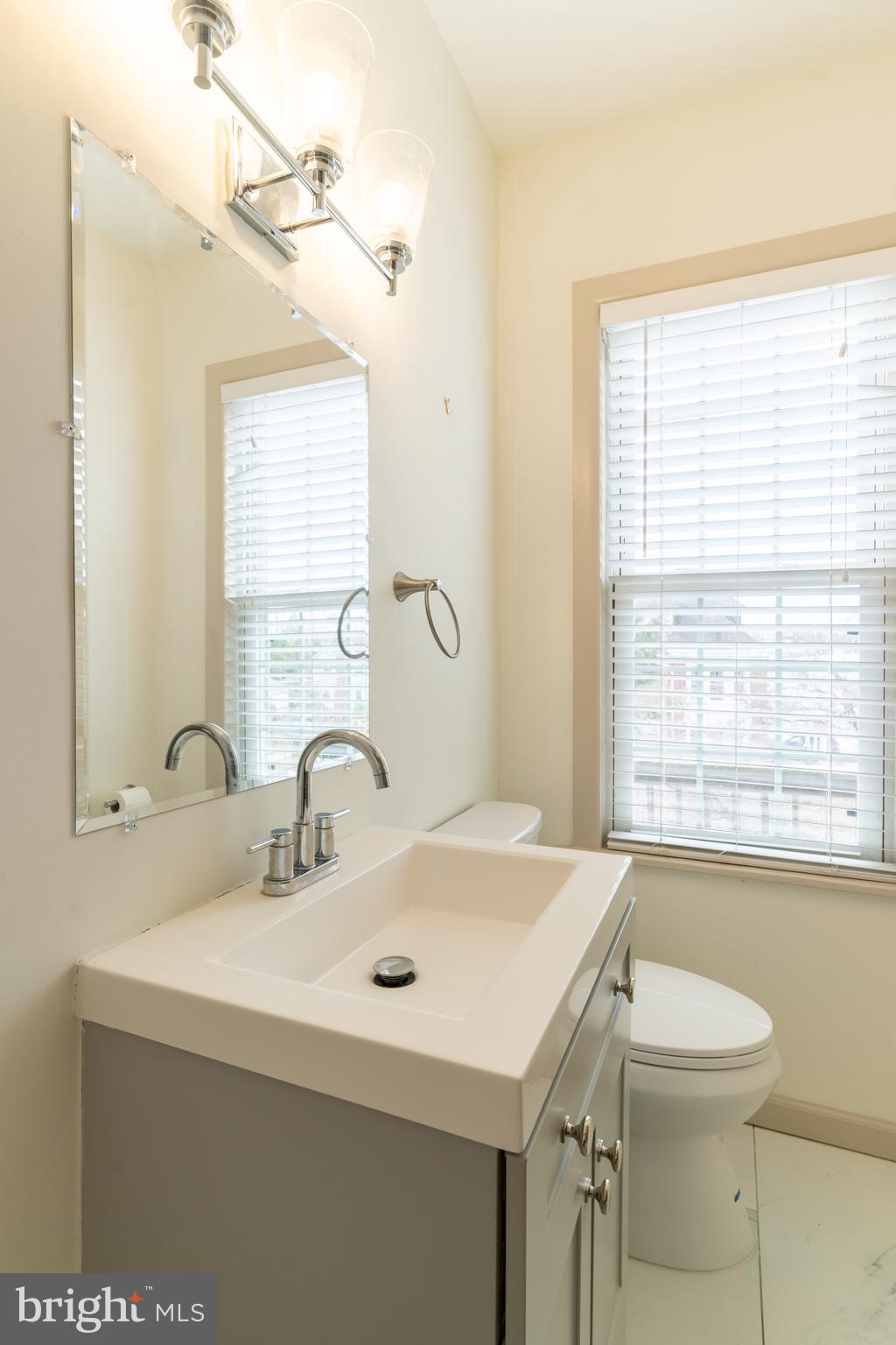 100 Potter Street, Unit 4 Haddonfield, NJ 08033 - Photo 16 of 17 a bathroom with a sink and a mirror