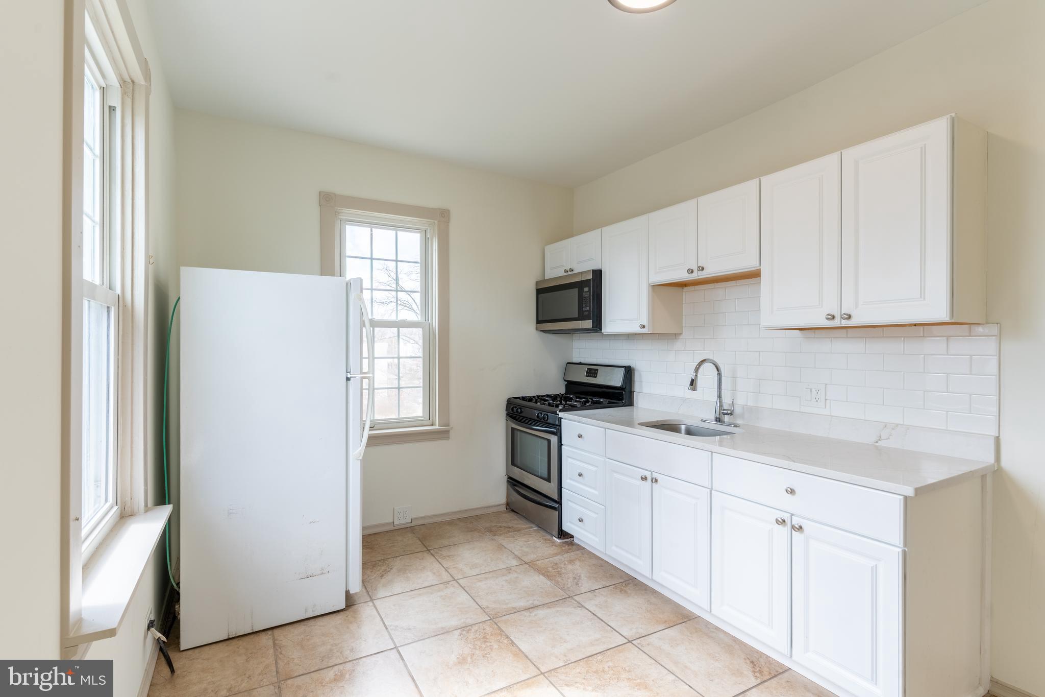 100 Potter Street, Unit 4 Haddonfield, NJ 08033 - Photo 3 of 17 a kitchen with white cabinets and white appliances