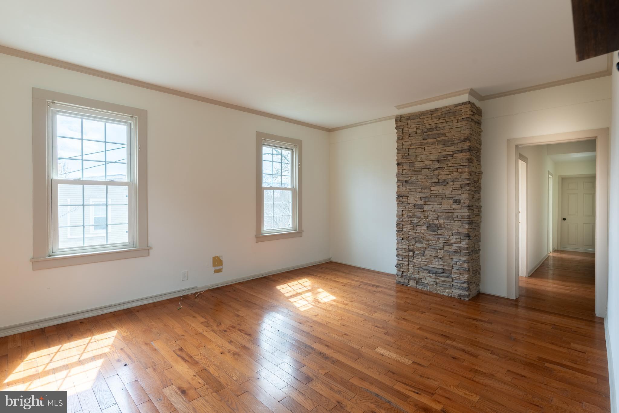 100 Potter Street, Unit 4 Haddonfield, NJ 08033 - Photo 5 of 17 a view of an empty room with wooden floor and a window