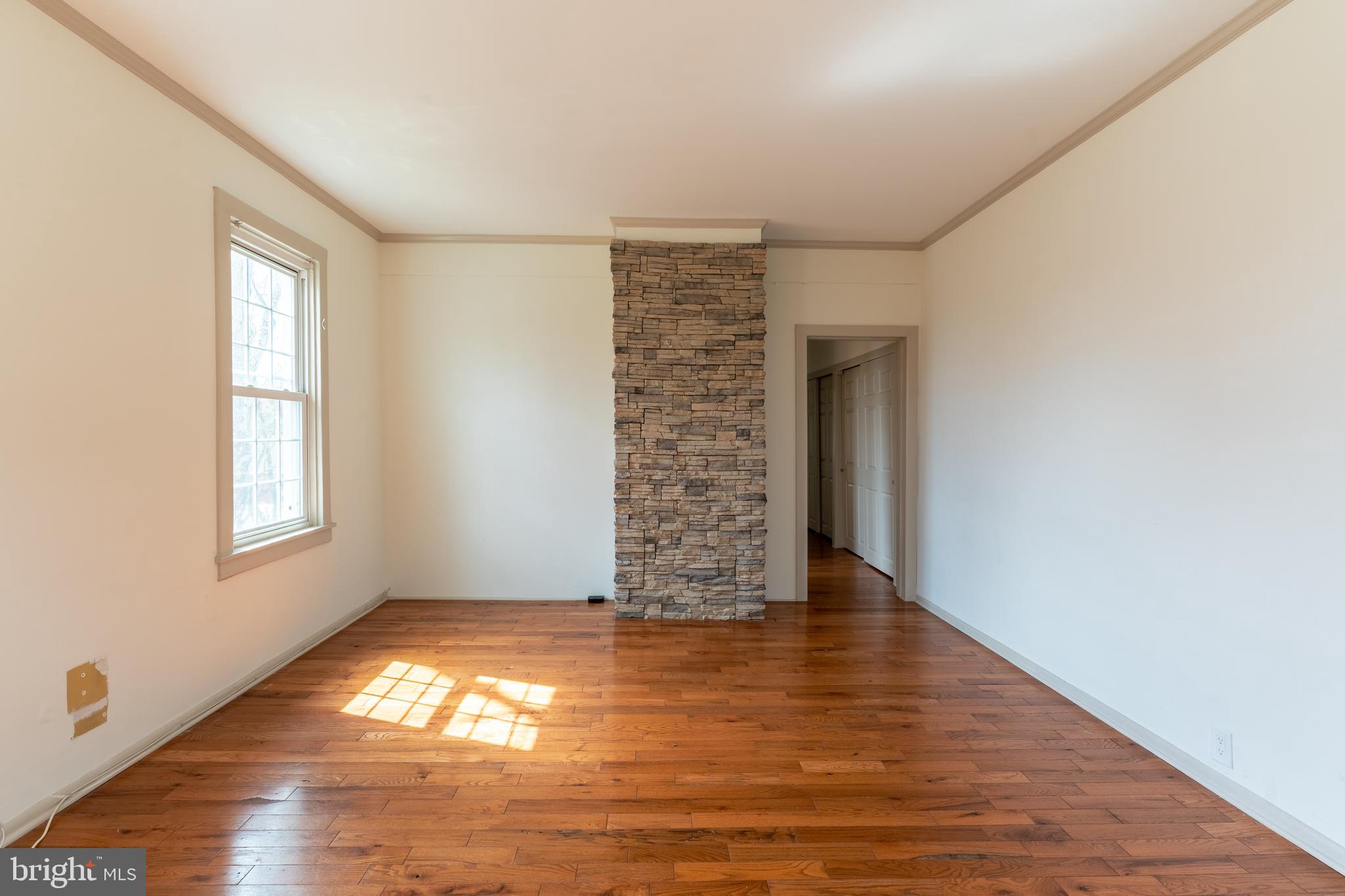 100 Potter Street, Unit 4 Haddonfield, NJ 08033 - Photo 6 of 17 a view of an empty room with window and wooden floor