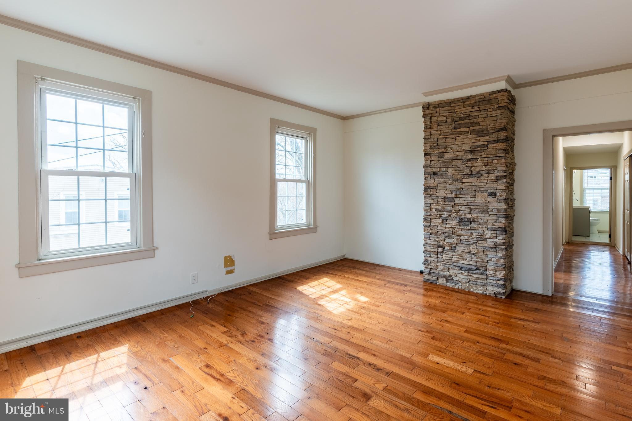 100 Potter Street, Unit 4 Haddonfield, NJ 08033 - Photo 7 of 17 a view of an empty room with window and wooden floor
