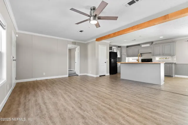 a view of a kitchen with a sink and a refrigerator