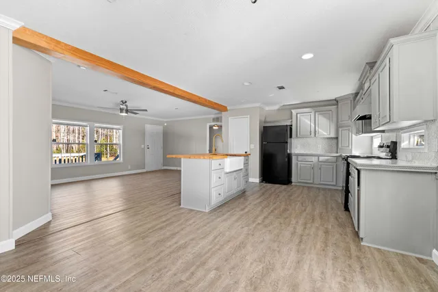a kitchen with stainless steel appliances kitchen island wooden cabinets and granite counter tops