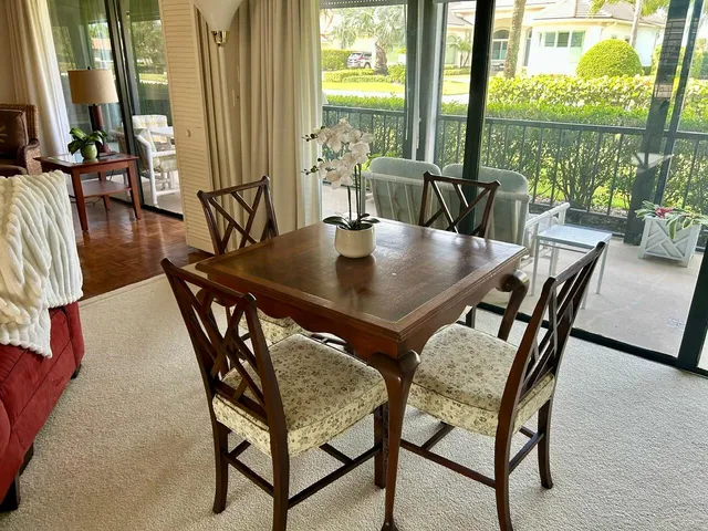 a dining room with furniture a chandelier and window