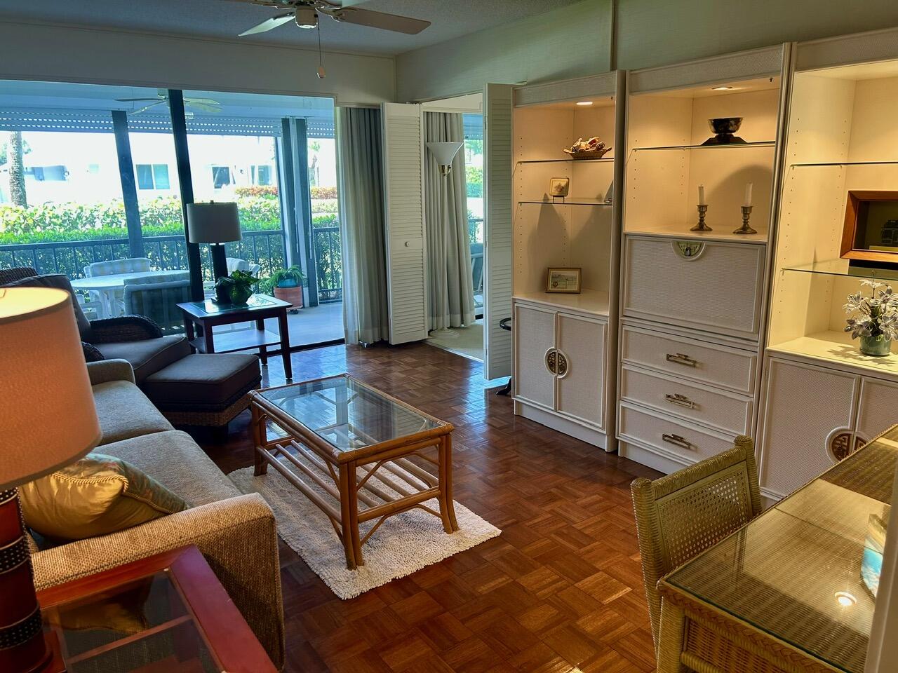 1 Southeast Turtle Creek Drive, Unit B Jupiter, FL 33469 - Photo 13 of 31 a living room with furniture a large window with white walls