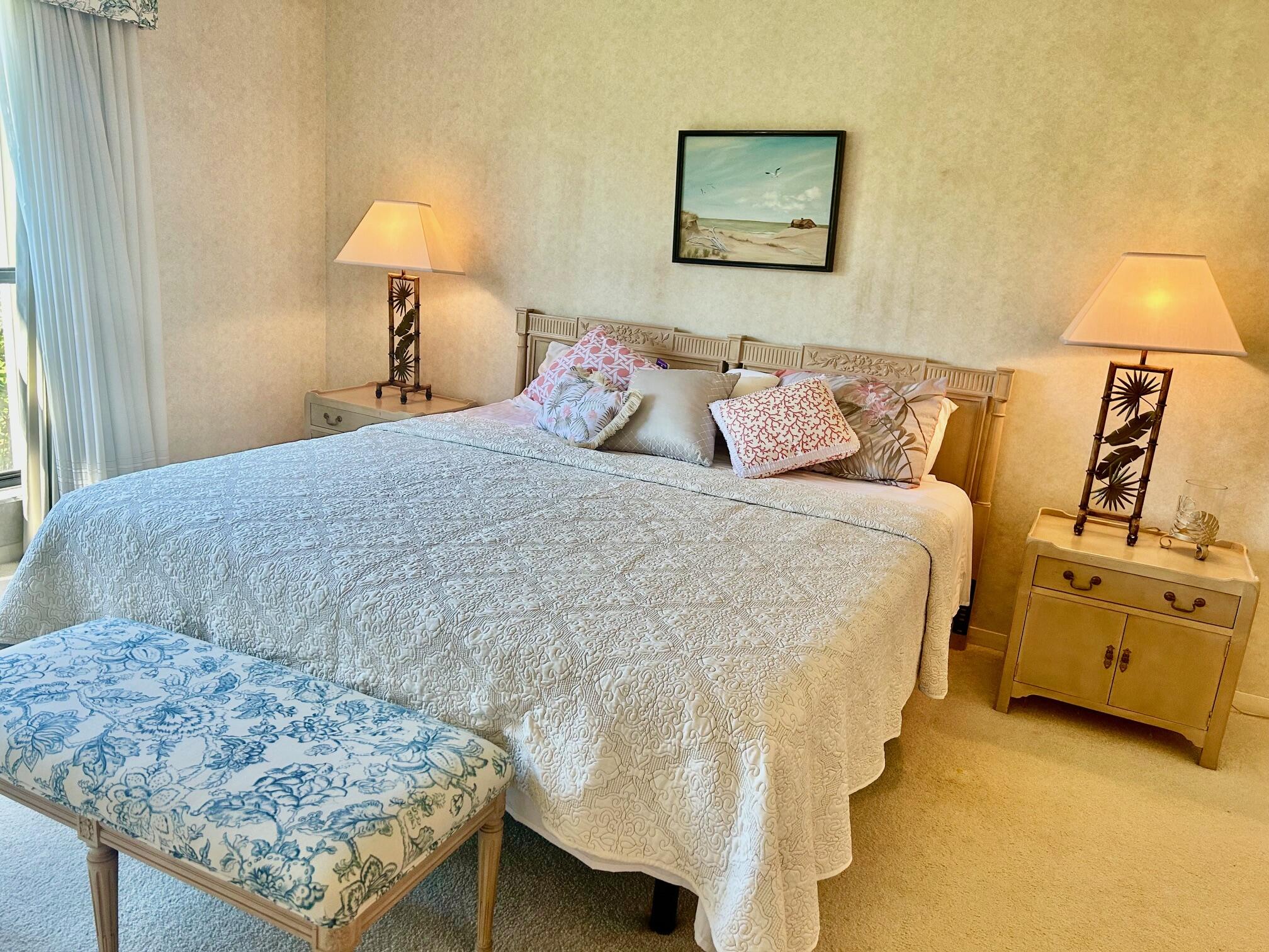 1 Southeast Turtle Creek Drive, Unit B Jupiter, FL 33469 - Photo 16 of 31 a bedroom with a bed and a lamp