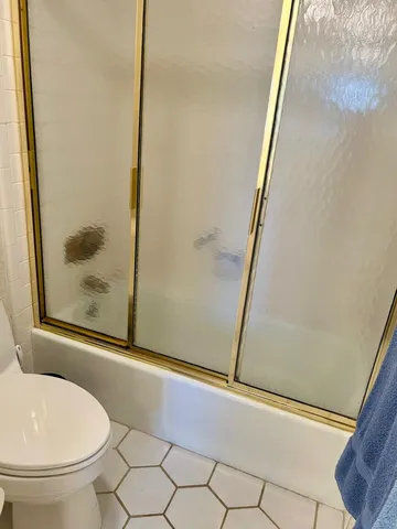 a bedroom with a bed and a lamp on dresser