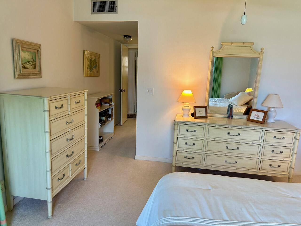 1 Southeast Turtle Creek Drive, Unit B Jupiter, FL 33469 - Photo 19 of 31 a bedroom with a bed and a dresser