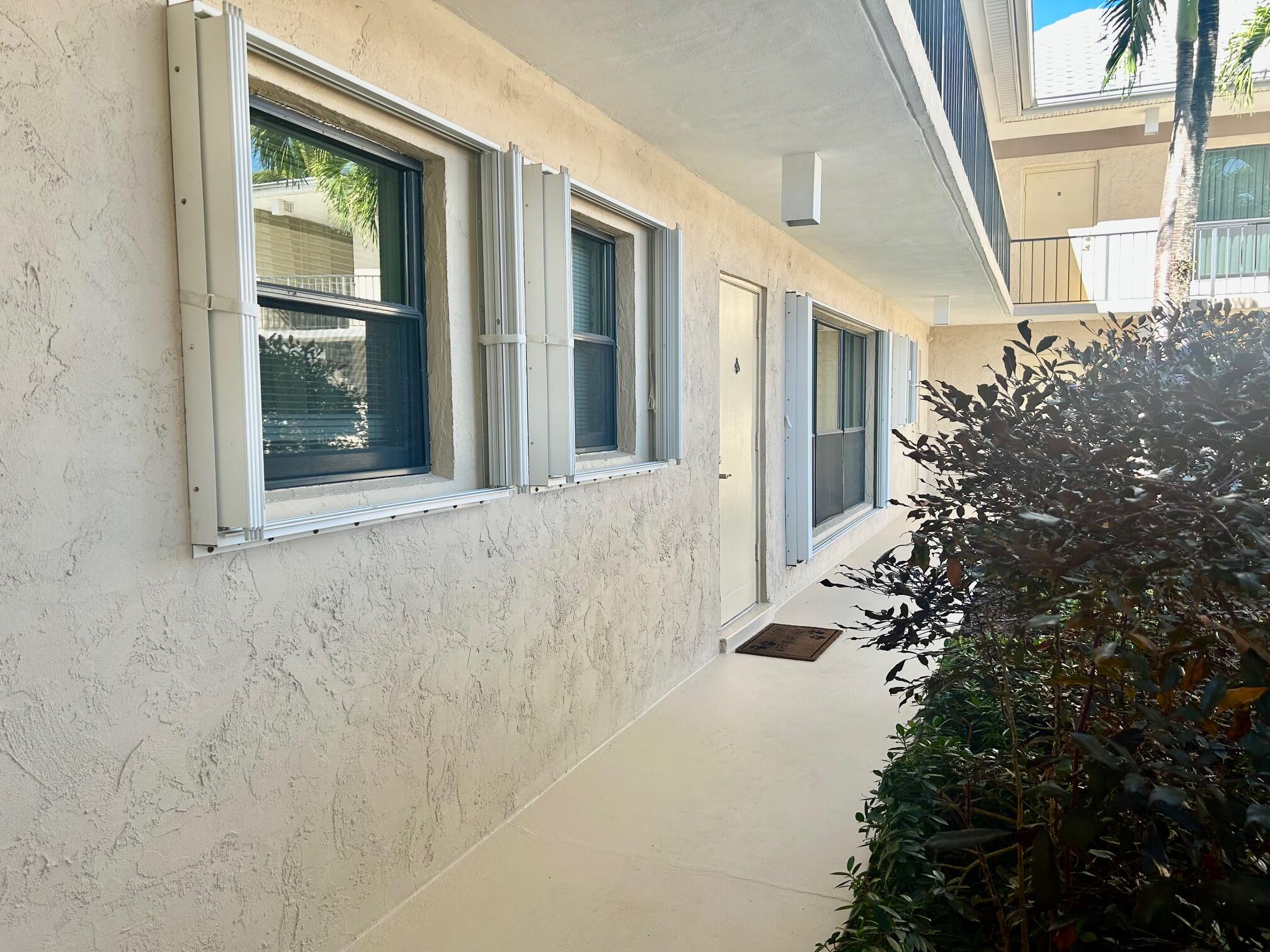 1 Southeast Turtle Creek Drive, Unit B Jupiter, FL 33469 - Photo 25 of 31 front view of a house with a potted plant