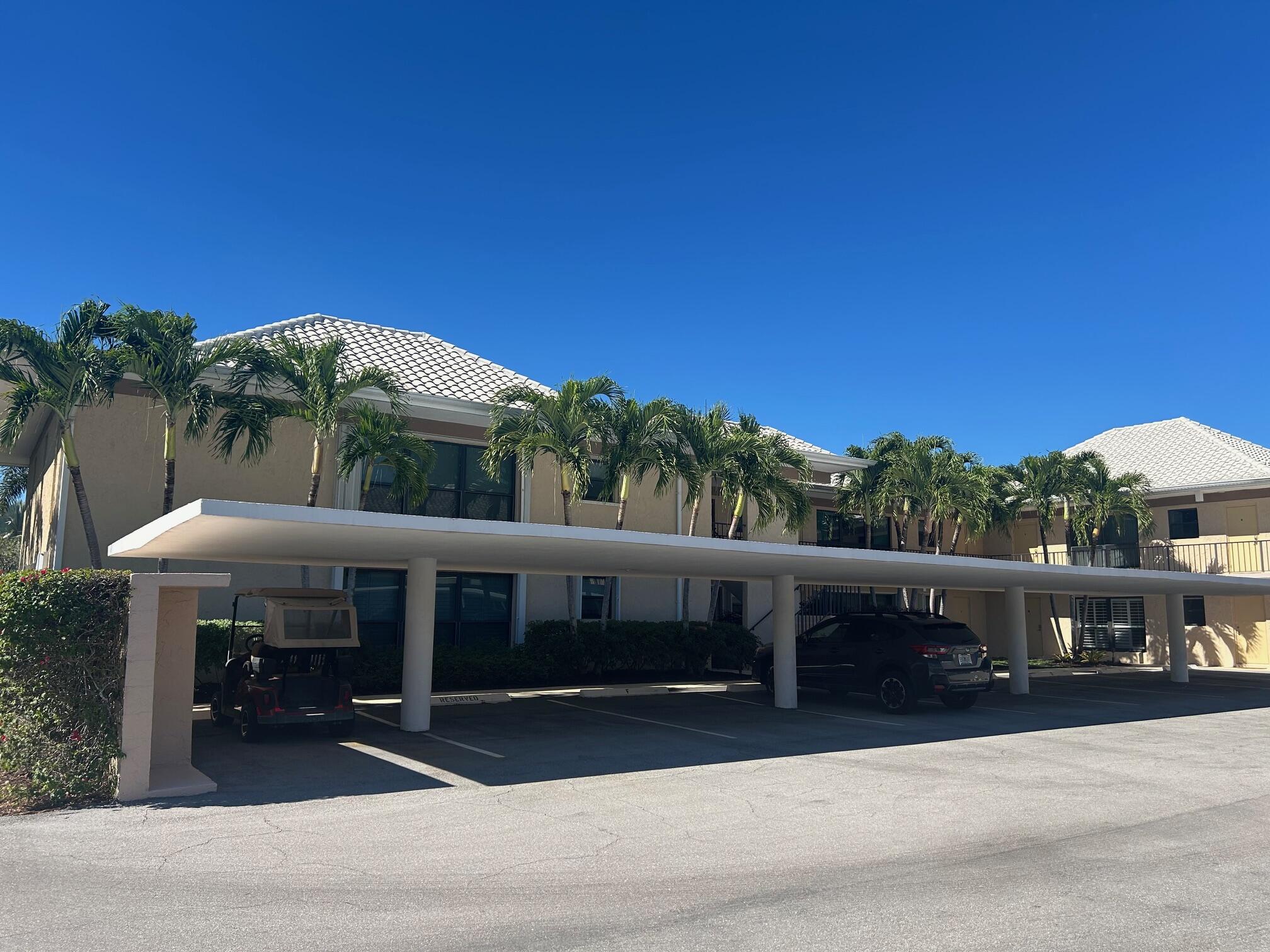 1 Southeast Turtle Creek Drive, Unit B Jupiter, FL 33469 - Photo 26 of 31 a view of a building with a yard