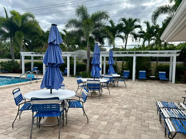 a view of a table and chairs in patio with a fire pit and a patio