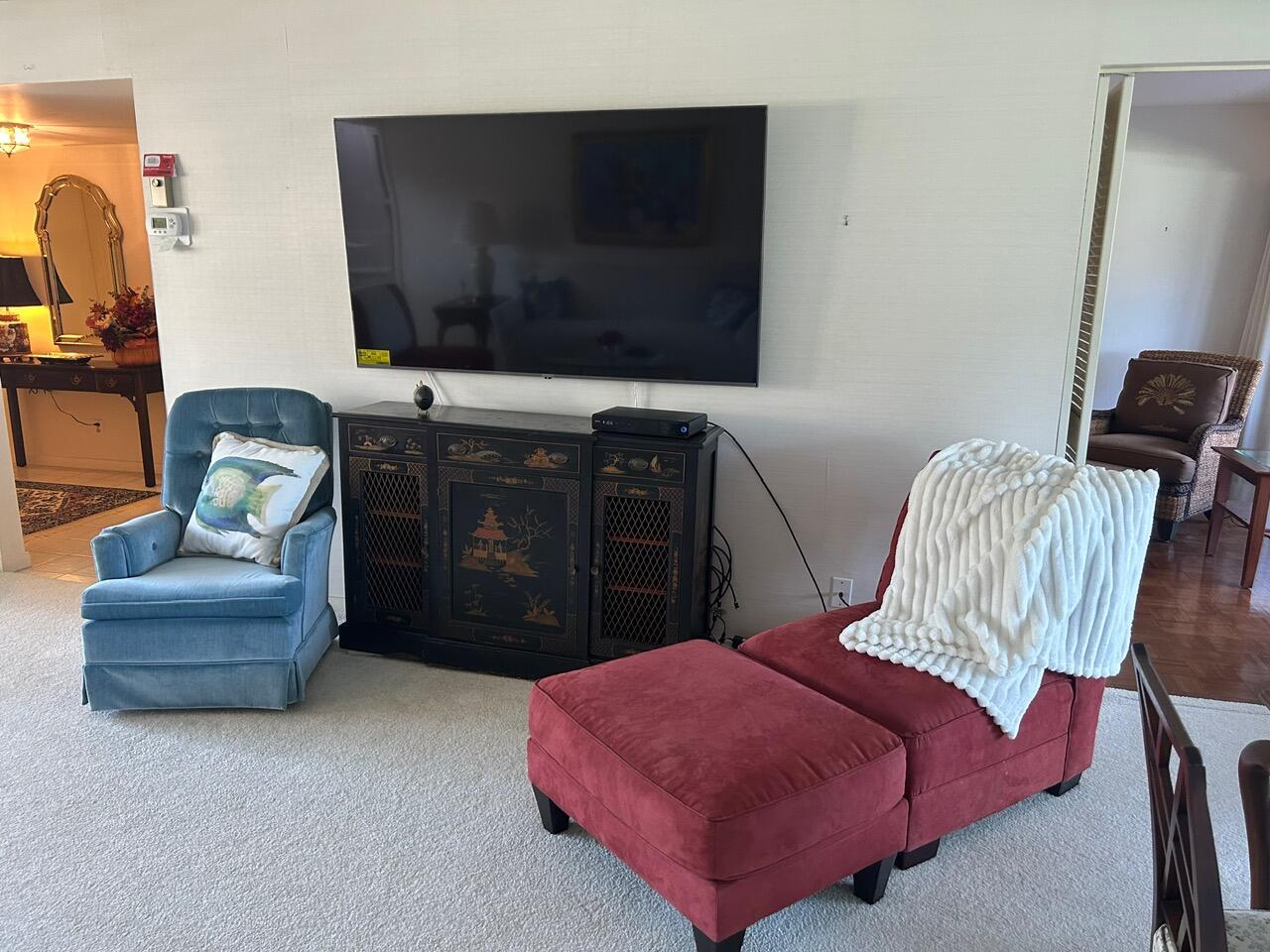 1 Southeast Turtle Creek Drive, Unit B Jupiter, FL 33469 - Photo 10 of 31 a living room with furniture and a flat screen tv