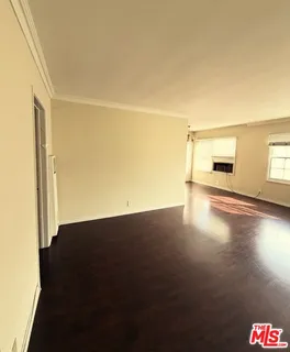 a view of a livingroom with wooden floor and a floor to ceiling window