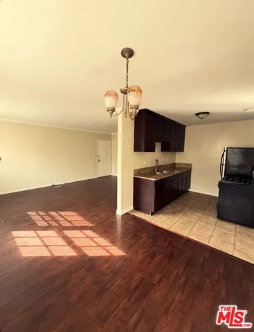 a living room with kitchen island furniture and a flat screen tv