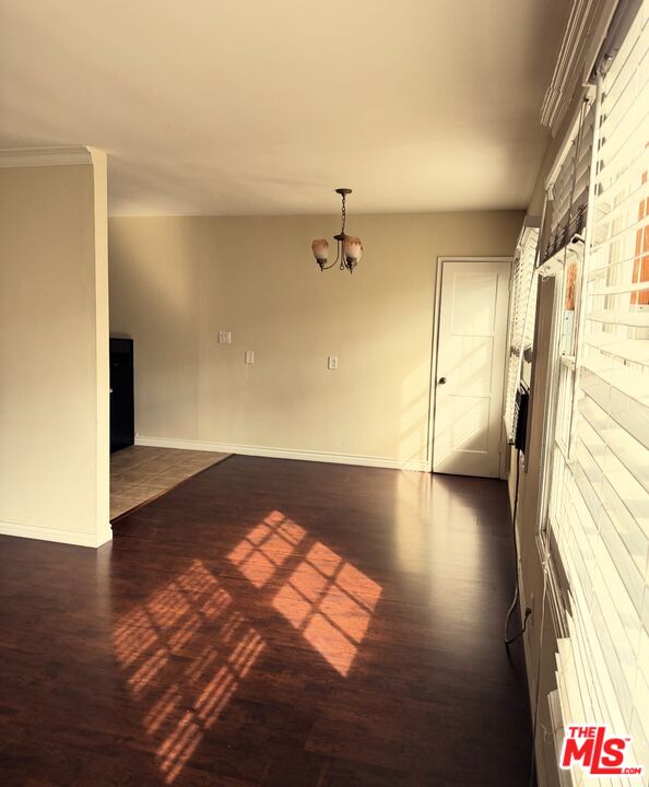 1242 Smithwood Drive, Unit 4 Los Angeles, CA 90035 - Photo 9 of 10 a view of a room with wooden floor and windows