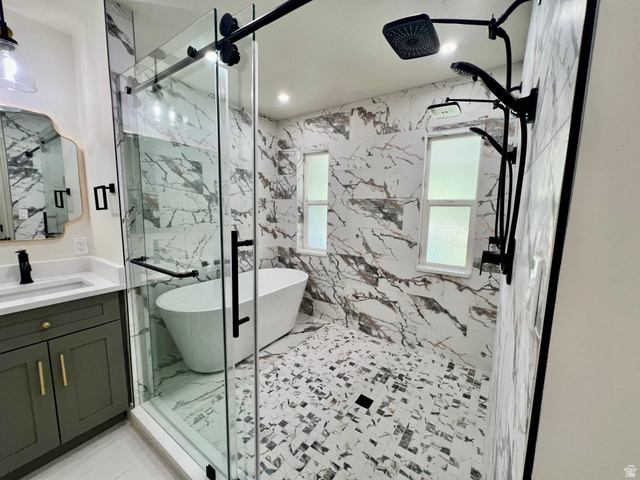 812 East Bates Cyn Road Tooele, UT 84074 - Photo 38 of 144 Expansive walk-in shower featuring a freestanding tub, floor-to-ceiling marble-look tile, and a multi-function matte black shower system
